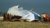 FILE - In this Dec. 23, 1988 photo, Scottish rescue workers and crash investigators search the area around the cockpit of Pan Am flight 103 in a farmer's field east of Lockerbie Scotland after a mid-air bombing killed all 259 passengers and crew,