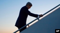 FILE - Secretary of State John Kerry walks up the stairs to board his aircraft at Andrews Air Force Base, Maryland, Aug. 14, 2015.