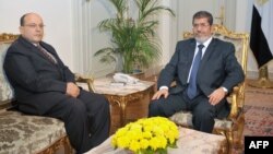 Egyptian President Mohamed Morsi (R) is seen with Prosecutor General Talaat Abdullah in a photo released by Morsi's office November 22, 2012.