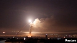 FILE - Missile fire is seen from Damascus, Syria, May 10, 2018.