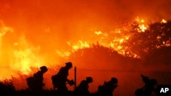 Firefighters battle the Saddleridge fire in Sylmar, Calif., Oct. 11, 2019.