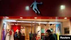 A man walks past a Qiaodan sports store in downtown Shanghai in 2012. Michael Jordan sued Qiaodan, accusing the firm of unauthorized use of his name.