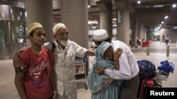 An Indian evacuee from Yemen hugs her son after arriving at the international airport in Mumbai, April 6, 2015.