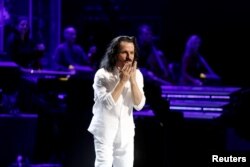 FILE - Composer Yanni reacts during the concert at Princess Nourah bint Abdulrahman University in Riyadh, Saudi Arabia, Dec. 3, 2017.