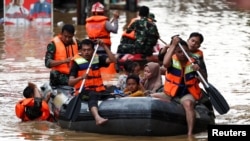 Rescuers evacuate people using a rubber boat from a flooded residential area following heavy rains in Jakarta, Indonesia.&nbsp;