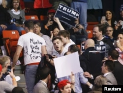 Protesters are escorted out of UIC Pavilion before Republican U.S. presidential candidate Donald Trump's rally at the University of Illinois at Chicago, March 11, 2016.