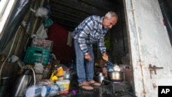 Nelson Antonio da Silva, who lost his home to flooding, shelters in a truck trailer in Canoas, Rio Grande do Sul state, Brazil, on May 10, 2024.