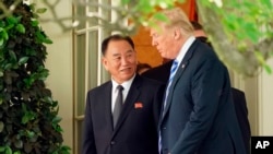 FILE - President Donald Trump talks with Kim Yong Chol, left, former North Korean military intelligence chief and one of leader Kim Jong Un's closest aides, as they walk from the Oval Office at the White House in Washington, June 1, 2018. 