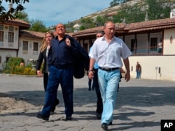FILE - Russian President Vladimir Putin, right, and former Italian Prime Minister Silvio Berlusconi visit the Khan's Palace in the town of Bakhchisarai, Crimea, Saturday, Sept. 12, 2015.