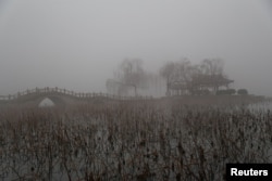 FILE - Heavy smog is seen during a polluted day at the Daming Lake in Jinan, Shandong province, China, Jan. 5, 2017.