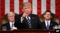 President Donald Trump addresses a joint session of Congress on Capitol Hill in Washington, Feb. 28, 2017. Vice President Mike Pence and House Speaker Paul Ryan of Wisconsin listen. 
