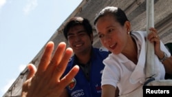 A supporter waves at presidential candidate Grace Poe during election campaigning in General Mariano Alvarez, Cavite in the Philippines May 3, 2016.