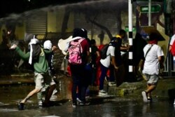 Anti-government protesters clash with police near Romelio Martinez stadium where a Copa Libertadores soccer match between Colombia's América de Cali and Brazil's Atlético Mineiro is being played, in Barranquilla, Colombia, May 13, 2021.