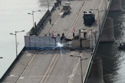 Iraqi security forces fire tear gas to disperse anti-government protesters in Baghdad, Iraq, Oct. 30, 2019.