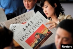 Foreign reporters and their government guides follow, in newspapers and broadcasted on television, the address by North Korean leader Kim Jong Un to the Workers' Party of Korea (WPK) congress, at a hotel in central Pyongyang, North Korea, May 8, 2016.