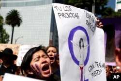 FILE - Women protest violence against women in Mexico City, Oct. 19, 2016.
