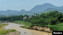 FILE - A Laotian fisherman casts his net in the Mekong river in Luang Prabang.