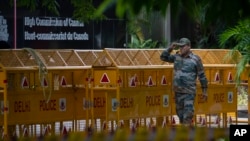 An Indian paramilitary soldier stands guard next to a police barricade outside the Canadian High Commission in New Delhi, India, Tuesday, Sept. 19, 2023. 