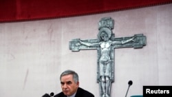 FILE - Cardinal Giovanni Angelo Becciu, caught up in a real estate scandal, speaks to the media a day after he resigned, in Rome, Italy, Sept. 25, 2020. A trial is now underway at the Vatican involving Becciu and nine other defendants. 
