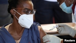 FILE - A healthcare worker receives the Johnson and Johnson coronavirus disease (COVID-19) vaccination at the Chris Hani Baragwanath Academic Hospital in Soweto, South Africa, Feb. 17, 2021.