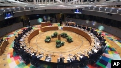 FILE - European Union leaders meet at a roundtable during an EU summit in Brussels, Belgium, Feb. 21, 2020.