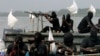 FILE - Militants are seen patrolling the creeks of the Niger Delta region of Nigeria, Jan. 30, 2007. 