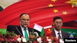 file - Ahsan Iqbal, left, Pakistan's Minister of Planning and Development and Yao Jing, Chinese Ambassador to Pakistan attend the launching ceremony of CPEC long-term cooperation plan in Islamabad, Pakistan, Dec. 18, 2017.