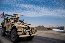 FILE - U.S. forces patrol Syrian oil fields, in eastern Syria, Oct. 28, 2019.