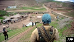 FILE - Afghan Nation Army (ANA) soldiers walk in formation during an operation in Bala Murghab district of Badghis province, March 26, 2017. 