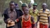 A man holds onto a girl as he brings her back to her family home after she tried to escape when she realized she is to be married, about 80 km (50 miles) from the town of Marigat in Baringo County, Kenya.