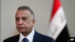 Iraqi Prime Minister Mustafa al-Kadhimi poses in his office during an interview with The Associated Press in Baghdad, Iraq, July 23, 2021.
