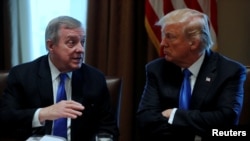 FILE - U.S. President Donald Trump listens to U.S. Senator Dick Durbin, D-Ill., during a meeting with legislators on immigration reform at the White House in Washington, Jan. 9, 2018. In a follow-up meeting January 11, Trump questioned why the United States would want to have immigrants from Haiti and African nations, referring to some as "s---hole countries," according to sources familiar with the comments.