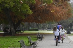 Kids ride their bikes at Las Heras park after lockdown measures to fight the COVID-19 novel coronavirus pandemic were relaxed, in Buenos Aires, on July 21, 2020.