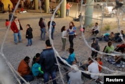 Migrants from Central America wait inside an enclosure, where they are being held by U.S. Customs and Border Protection, after crossing the U.S.-Mexico border illegally and turning themselves in to request asylum, in El Paso, Texas, March 29, 2019.