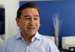 FILE - William Santana Li, CEO of Knightscope Inc., talks about the company's K5 security robot at company headquarters in Mountain View, Calif., June 26, 2017.