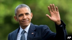 FILE - President Barack Obama waves as he walks across the South Lawn of the White House, in Washington.