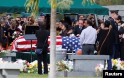 The flag-draped coffin of Marjory Stoneman Douglas High School student Peter Wang is seen at his burial service in North Lauderdale, Fla., Feb. 20, 2018.