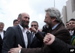 Journalists Can Dundar, right, and Erdem Gul, Ankara bureau chief of Cumhuriyet newspaper, speak before the start of their trial, hours before the attack on Can Dundar outside city's main courthouse in Istanbul, May 6, 2016.