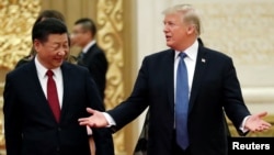 U.S. President Donald Trump and China's President Xi Jinping arrive for a state dinner at the Great Hall of the People in Beijing, Nov. 9, 2017. Trump has approved a plan to impose tariffs on billions of dollars worth of Chinese goods.