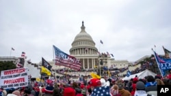 FILE - Rioters loyal to President Donald Trump rally at the U.S. Capitol in Washington on Jan. 6, 2021. On Jan. 28, 2024, a retired judge recommended to Illinois election officials that former President Trump's name should be removed from the Illinois primary ballot.