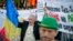 Romania Canada Gold Mine Protest: FILE -A man holding a banner that reads "Stop the Rosia Montana siege" shouts during a protest in Bucharest, Romania, in this Sunday, Sept. 22, 2013 file photo.