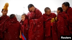 FILE - Tibetan monks attend a ceremony at the Langmu Lamasery during the "Sunbathing Buddha Festival", in Gannan Tibetan Autonomous Prefecture, Gansu Province, China, Feb. 17, 2019.