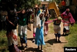 FILE - Women mourn during the funeral a construction engineer who died during a stampede after police fired warning shots at an anti-government protest in Bishoftu during Irreecha, the thanksgiving festival of the Oromo people, Oct. 3, 2016.