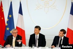 French President Emmanuel Macron, his Chinese counterpart Xi Jinping and European Commission President Jean-Claude Juncker hold a news conference with German Chancellor Angela Merkel at the Elysee presidential palace in Paris, France, March 26, 2019.