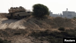 An Israeli tank patrols just outside the border with the northern Gaza Strip October 24, 2012. 