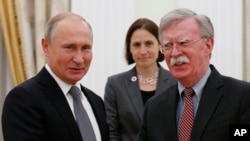 Russian President Vladimir Putin, left, and U.S. national security adviser John Bolton meet in the Kremlin in Moscow, Oct. 23, 2018. 