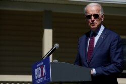 FILE - Joe Biden makes a statement about health care outside St. James-Santee Family Health Center in McClellanville, S.C., Feb. 27, 2020.