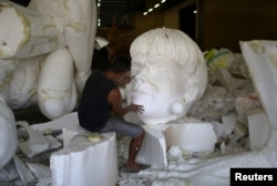 A worker from the Imperatriz Leopoldinense samba school prepares part of a carnival float at the school's carnival production headquarters in Rio de Janeiro, Brazil, Feb. 9, 2017.