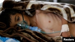 FILE - An 8-year-old malnourished boy lies on a bed in the emergency ward of a hospital in Sanaa, Yemen, Sept. 27, 2016.