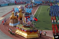 A large parade marks the country's 40th of Victory Over Genocide Day at National Olympic Stadium, in Phnom Penh, Cambodia, Monday, Jan. 7, 2019. Ten of thousand supporters on Monday marked the 40th anniversary of the ousted of brutal Khmer Rouge regime. (AP Photo/Heng Sinith)